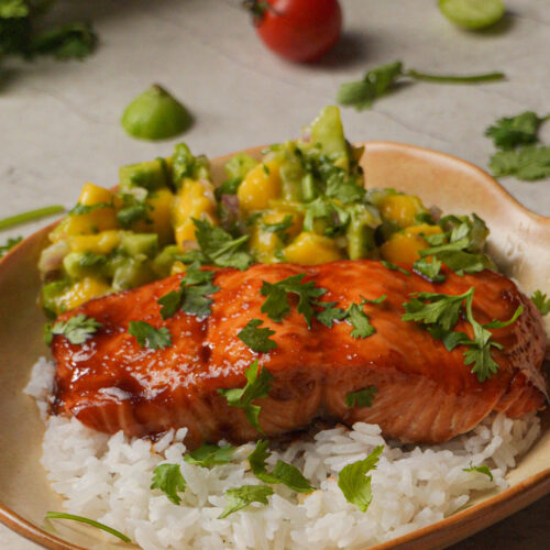 orange salmon with avocado mango salad